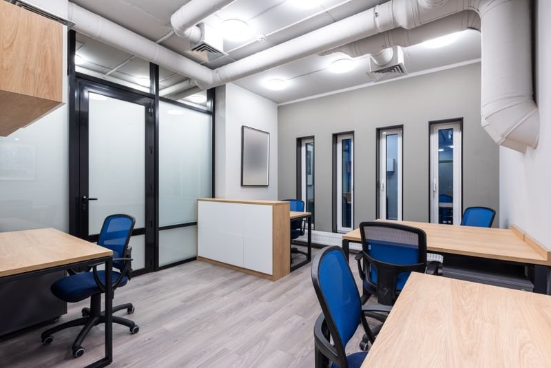 Modular office furniture with wooden desks and task chairs