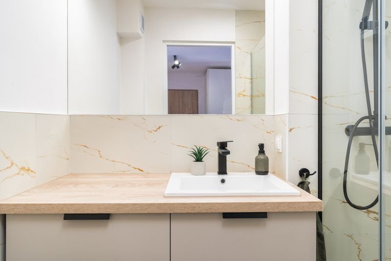 Bathroom vanity unit with a wooden countertop and under-sink storage