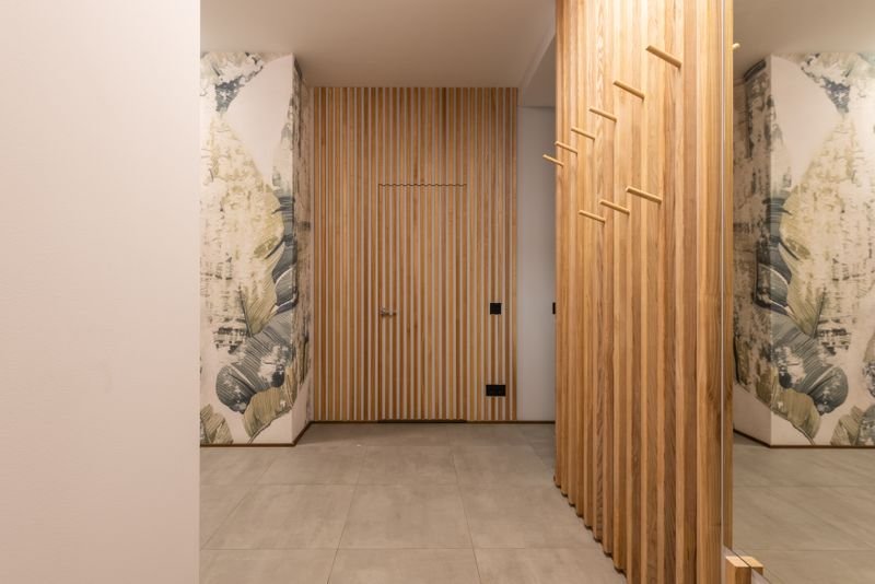 Hallway finished with wooden wall paneling along its full length