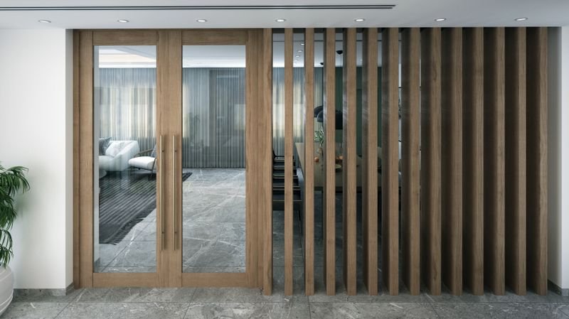 Wooden partition with vertical slats and a glass panel dividing an interior